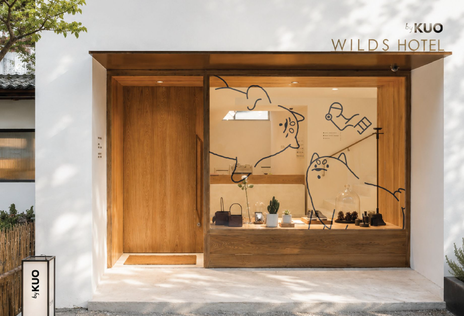 by KUO hotel entrance with Kuo and Bobo window decals